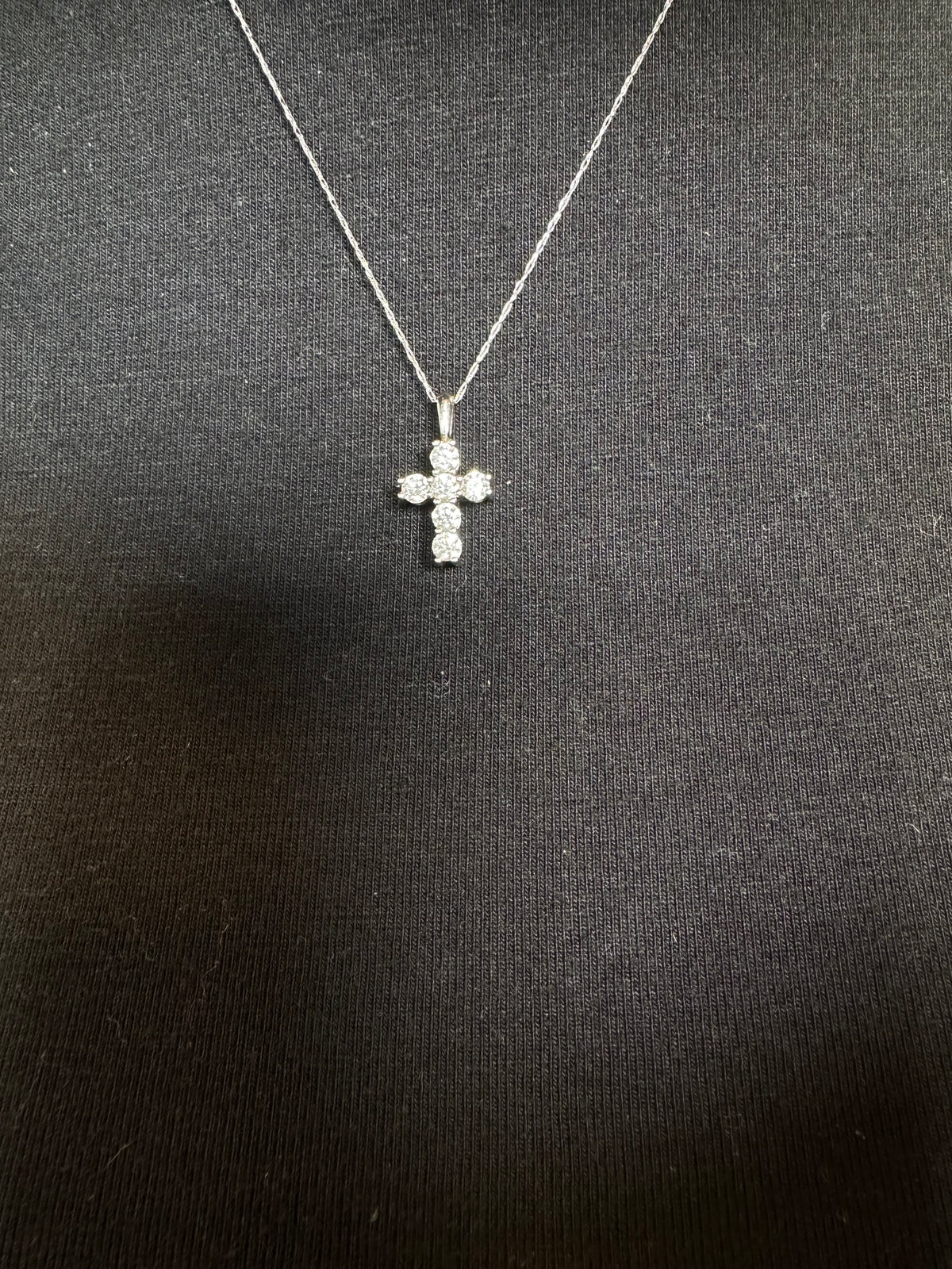 Detail of the gold chain and diamond cross pendant by Statement92