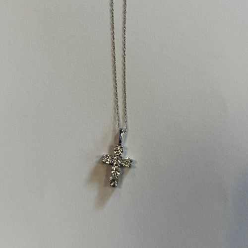 Detail of the gold chain and diamond cross pendant by Statement92