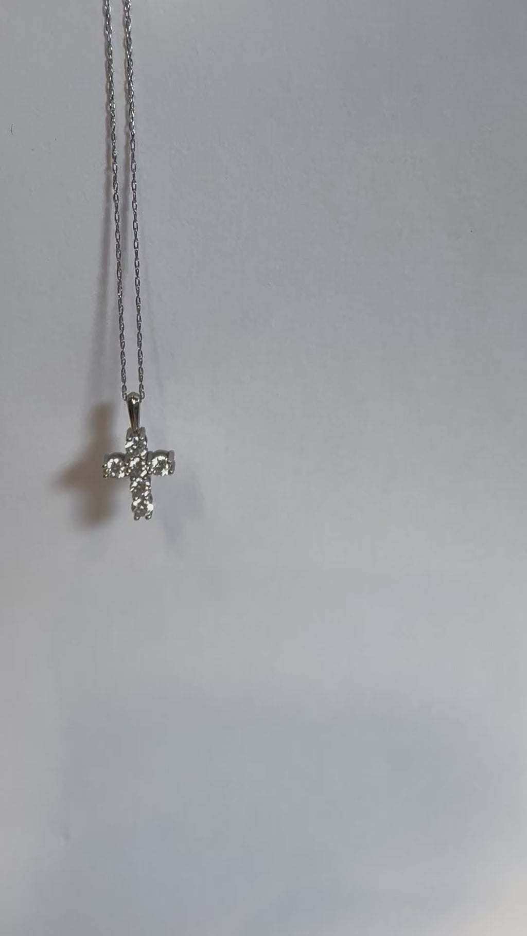 Detail of the gold chain and diamond cross pendant by Statement92