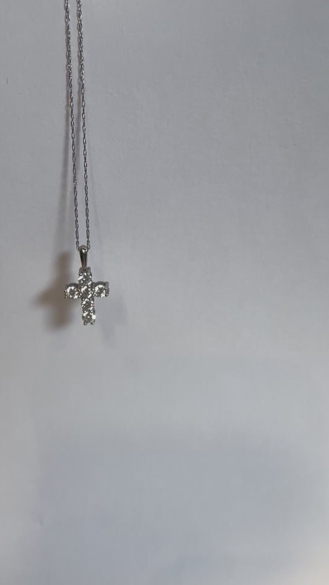 Detail of the gold chain and diamond cross pendant by Statement92