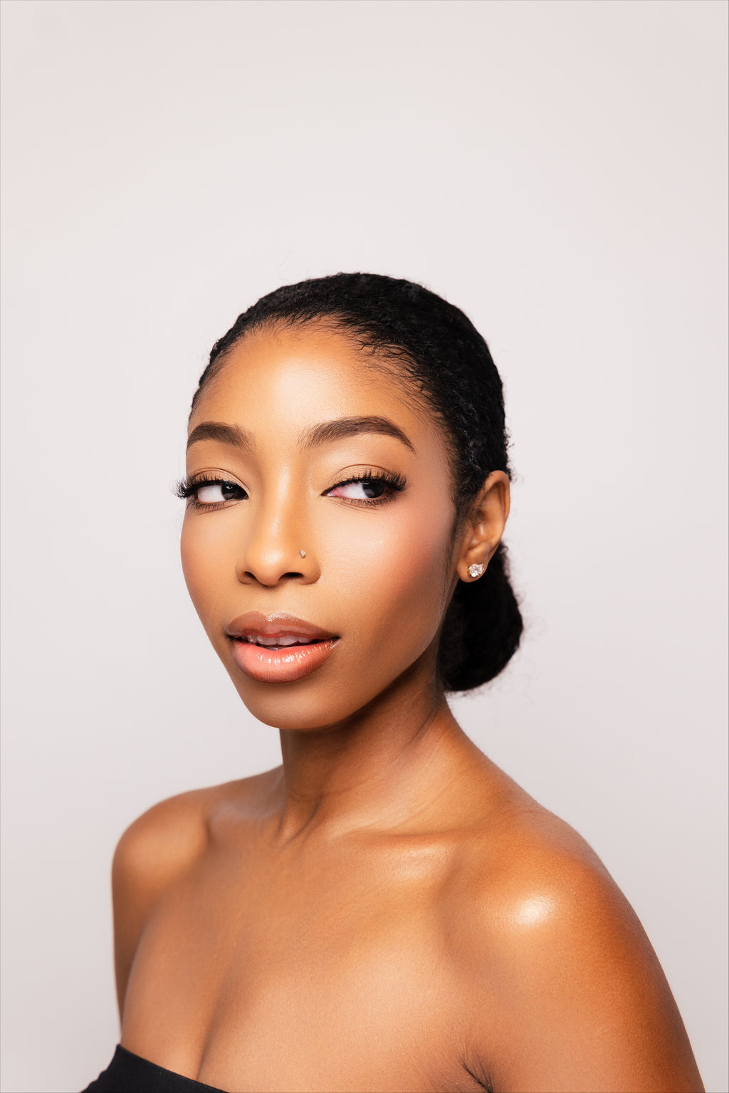 Everyday diamond stud earrings worn in a portrait by Statement92